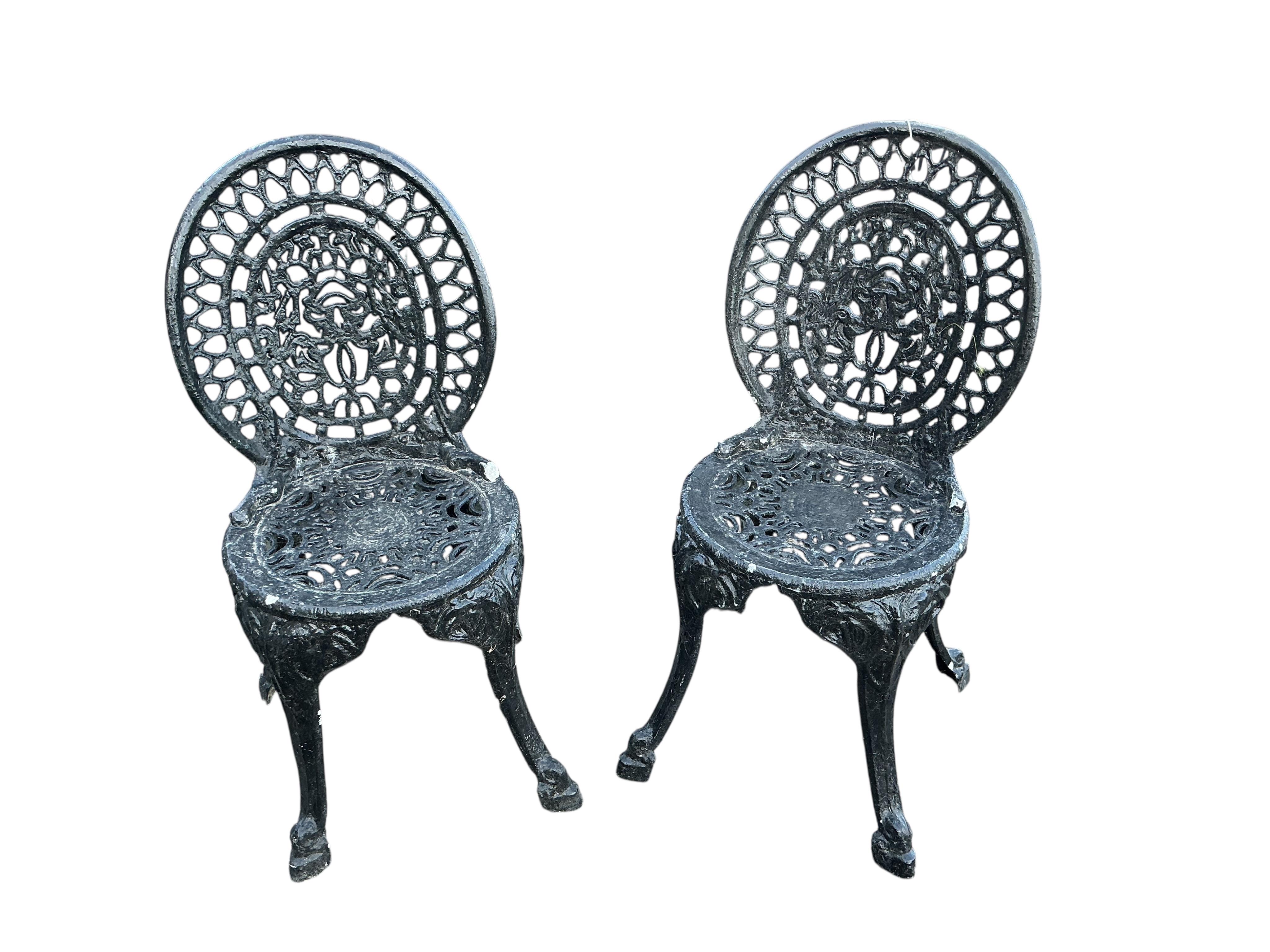 A Victorian style circular aluminium garden table, diameter 60cm together with two pairs of chairs